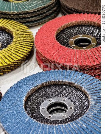Different colored abrasive discs stacked on a table in a workshop during daytime Different colored abrasive discs stacked on a table in a workshop during daytime 134050779