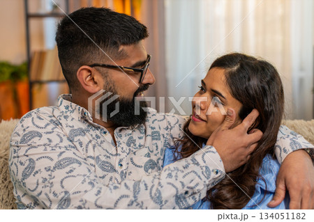 Indian family couple man woman touching face and looking at each other with love and tenderness Indian family couple man woman touching face and looking at each other with love and tenderness 134051182