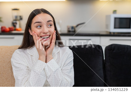 Young woman grabs phone with wow reaction happy surprise celebrates good news big smile excited joy Young woman grabs phone with wow reaction happy surprise celebrates good news big smile excited joy 134051229