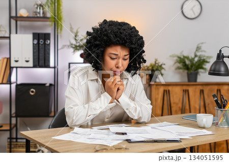African American businesswoman stressed by bills debt and high taxes fears looming major bankruptcy African American businesswoman stressed by bills debt and high taxes fears looming major bankruptcy 134051595