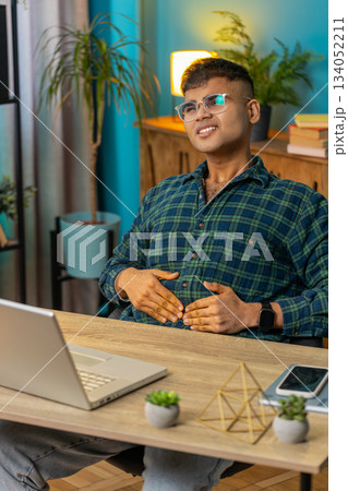 Indian man feeling sudden strong abdominal stomach ache gastritis problem diarrhea at home office Indian man feeling sudden strong abdominal stomach ache gastritis problem diarrhea at home office 134052211