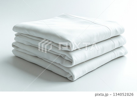 Refined aesthetics. Cotton sheets on a white background. Stack of comfortable white sheets. Refined aesthetics. Cotton sheets on a white background. Stack of comfortable white sheets. 134052826