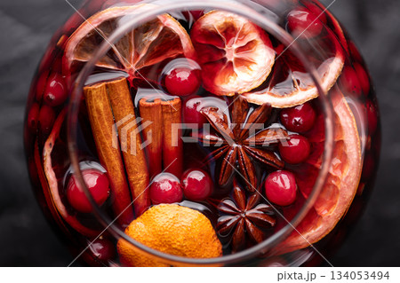 Close up of red mulled wine glass with slices of orange Close up of red mulled wine glass with slices of orange 134053494