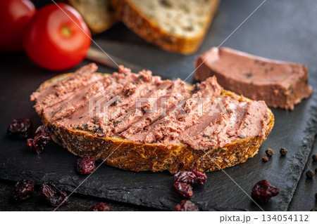 Pate on a slice of bread on black table. 134054112