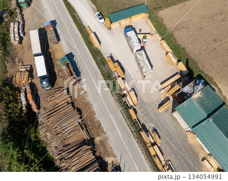 Aerial view of a sawmill factory with stacks of processed lumber and timber. Aerial view of a sawmill factory with stacks of processed lumber and timber. 134054991