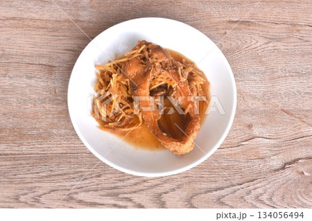 deep fried chop red Tilapia or mango fish slice dressing soy sauce and celery on plate  134056494