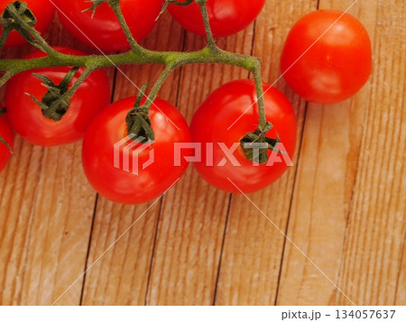 Bunch of red tomatoes are on a wooden table 134057637