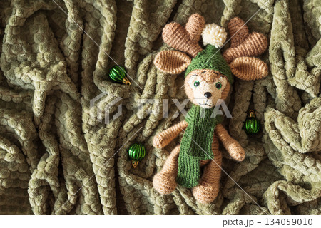 Crocheted Reindeer with Christmas Ornaments on Cozy Holiday Blanket Crocheted Reindeer with Christmas Ornaments on Cozy Holiday Blanket 134059010