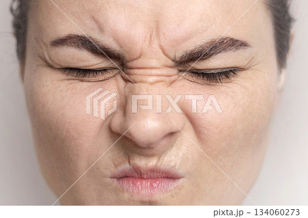 close up photo of woman shows her facial wrinkles on her face. Folds on the skin. close up photo of woman shows her facial wrinkles on her face. Folds on the skin. 134060273