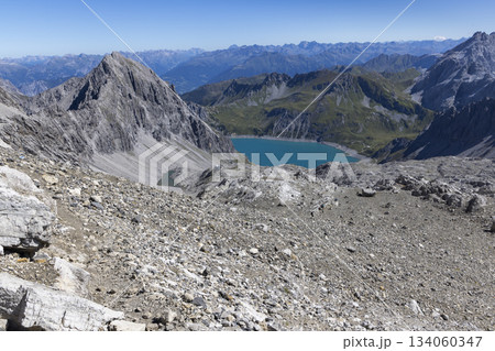 View from Schesaplana mountain in Vorarlberg with Lunersee lake and Totalp-Hutte visible in Ratikon mountain range 134060347