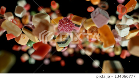 Colorful candies flying in mid-air against a black background. Dynamic macro shot with vibrant colors, shallow depth of field, and motion freeze. Perfect for food, advertising, and creative design. Colorful candies flying in mid-air against a black background. Dynamic macro shot with vibrant colors, shallow depth of field, and motion freeze. Perfect for food, advertising, and creative design. 134060777