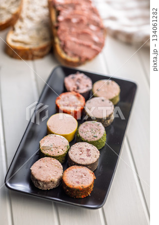 Liver pate with cranberries on plate on white table. Liver pate with cranberries on plate on white table. 134061282