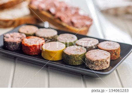 Liver pate with cranberries on plate on white table. Liver pate with cranberries on plate on white table. 134061283