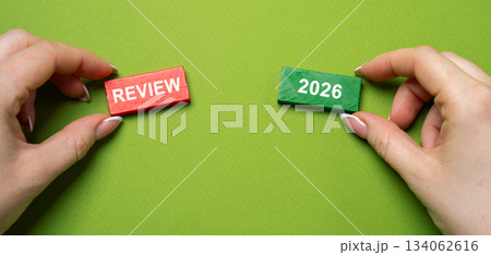 Audit of business and enterprises, government agencies and services. Annual report and financial performance indicators. Business and finance concept. Blocks with the words Review 2026 in hand. Audit of business and enterprises, government agencies and services. Annual report and financial performance indicators. Business and finance concept. Blocks with the words Review 2026 in hand. 134062616