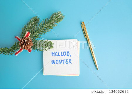 Notes Hello winter and a Christmas tree branch and pen. Concept of the beginning of a new winter season and new month 134062652