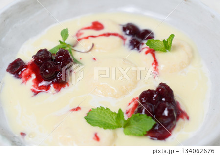 Syrniki in milk-vanilla sauce with cherry jam and mint Syrniki in milk-vanilla sauce with cherry jam and mint 134062676