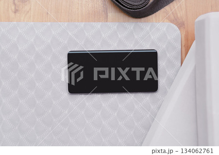 Blank phone on yoga mat with blocks and strap color of the year 2026 cloud white dancer 134062761