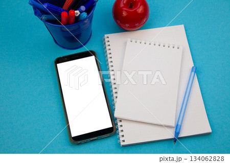 Mobile phone mockup background top view. Workplace copy space. Notepad, notebook and pen. Study and work. Planning. Self-learning. Online course. Education remotely. Cellphone Mobile phone mockup background top view. Workplace copy space. Notepad, notebook and pen. Study and work. Planning. Self-learning. Online course. Education remotely. Cellphone 134062828
