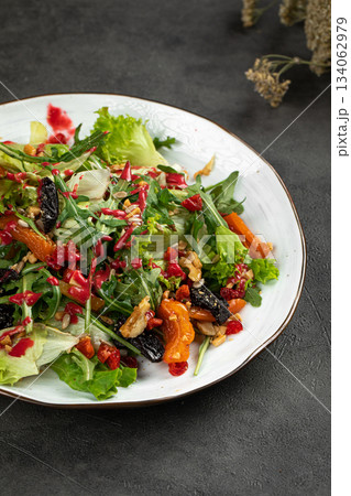 Fresh mixed salad with nuts and berries Fresh mixed salad with nuts and berries 134062979