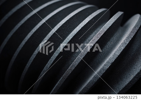 Spiral textured surface with contrasting light and shadows in dark setting Spiral textured surface with contrasting light and shadows in dark setting 134063225