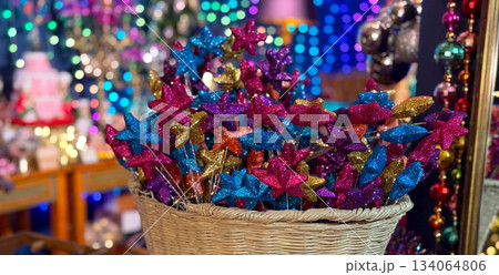 Banner Christmas Wicker basket filled with glitter star picks in bright holiday colors. Festive creative decor, Christmas craft charm, joyful winter celebration and magical party inspiration. 134064806