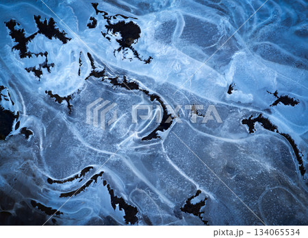 winter background shapes on frozen water surface winter background shapes on frozen water surface 134065534