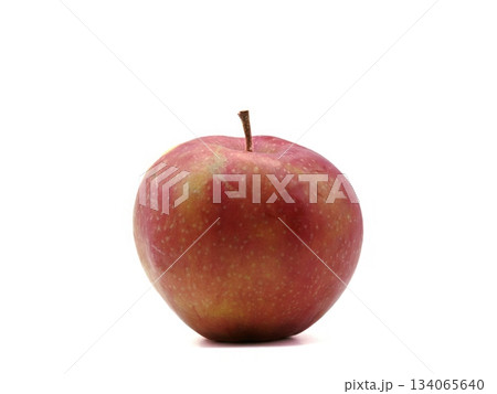 Bright red apple photograph highlighting glossy surface and rounded shape with minimal aesthetic details Bright red apple photograph highlighting glossy surface and rounded shape with minimal aesthetic details 134065640