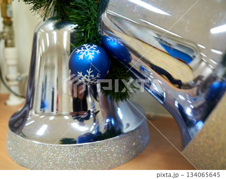Seasonal display with shiny ornaments, Christmas window showcase with sparkling decorations and pine 134065645