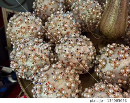 Handcrafted Christmas balls decorated with pearls and colorful gems. Festive craftwork, winter tradition, joyful ornament collection, nostalgic holiday atmosphere and gift inspiration Handcrafted Christmas balls decorated with pearls and colorful gems. Festive craftwork, winter tradition, joyful ornament collection, nostalgic holiday atmosphere and gift inspiration 134065688