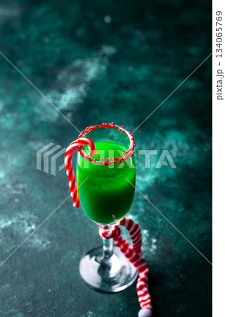 Christmas green cocktail punch with candy cane Christmas green cocktail punch with candy cane 134065769