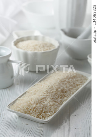 Raw organic rice in white dish. Raw organic rice in white dish. 134065828