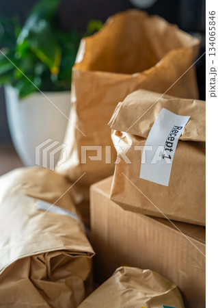 Close-up of brown paper bags with meal kits labeled Recept or Recipe. Subscription-based food delivery sorted by recipes. Close-up of brown paper bags with meal kits labeled Recept or Recipe. Subscription-based food delivery sorted by recipes. 134065846