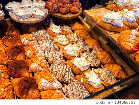 Assortment of sweet bakery and pastry displayed in showcase glass box. High quality photo. Assortment of sweet bakery and pastry displayed in showcase glass box. High quality photo. 134066255