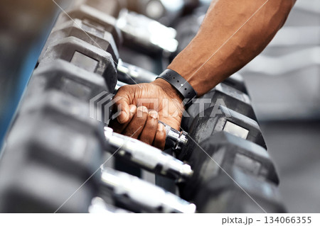 Sports equipment for gym concept. Unrecognizable african american muscular bodybuilder hand grabbing barbell at modern gym, copy space. Cropped of black athletic man working out with dumbbells 134066355