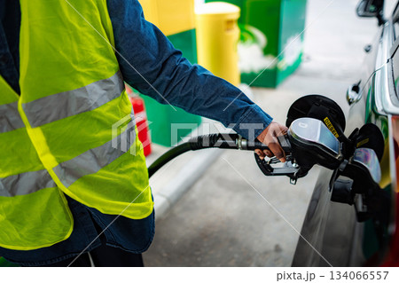 Person refueling car with diesel at gas station Person refueling car with diesel at gas station 134066557