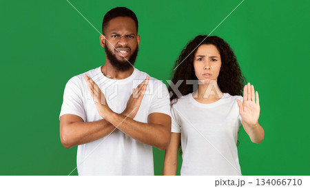 Don't Do It. Multiethnic Woman And Man Gesturing Stop And Crossing Hands Forbidding And Disapproving Something Standing On Green Studio Background. Restriction, Warning Concept. Panorama Don't Do It. Multiethnic Woman And Man Gesturing Stop And Crossing Hands Forbidding And Disapproving Something Standing On Green Studio Background. Restriction, Warning Concept. Panorama 134066710