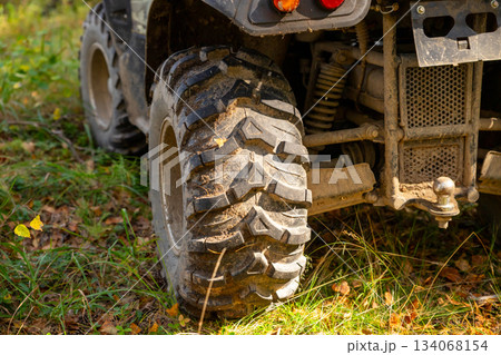 dirty rear left wheel of an ATV dirty rear left wheel of an ATV 134068154