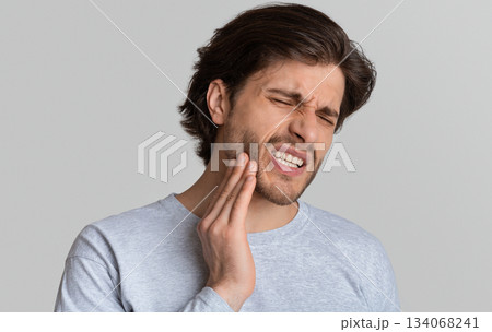 Dental problems concept. Man suffering from bad toothache, empty space 134068241