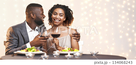 Young afro man and woman having dinner in restaurant, drinking wine, celebrating St. Valentine's Day Young afro man and woman having dinner in restaurant, drinking wine, celebrating St. Valentine's Day 134068243