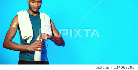 Hydration. Sportsman After Workout Opening Bottle Of Water Standing In Studio On Blue Background. Free Space, Cropped 134068293