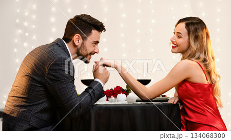 Gallant Man Kissing Hand Of His Pleased Girfriend On Romantic Date In Restaurant 134068300