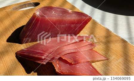 Sophisticated serving of expertly sliced ham with detailed texture 134069095