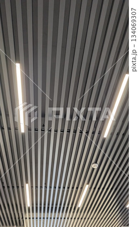 Stylish metal slat ceiling with integrated linear illumination effects Stylish metal slat ceiling with integrated linear illumination effects 134069307