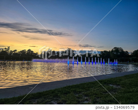 Sunset Serenity Fountain Silhouette Against Golden Sky Sunset Serenity Fountain Silhouette Against Golden Sky 134069579