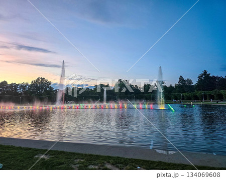 Sunset Serenity Fountain Silhouette Against Golden Sky 134069608