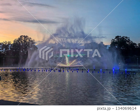 Sunset Serenity Fountain Silhouette Against Golden Sky 134069614