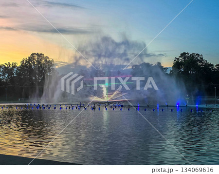 Sunset Serenity Fountain Silhouette Against Golden Sky 134069616