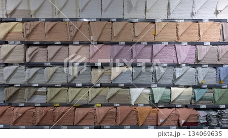 Displays fabric and paper swatches organized by color tone Displays fabric and paper swatches organized by color tone 134069635