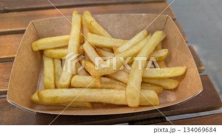 Freshly prepared golden fries in rustic outdoor cafe setting Freshly prepared golden fries in rustic outdoor cafe setting 134069684