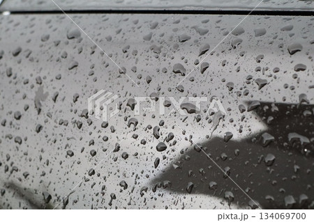 dark cityscape emphasizing water droplets on window and solitary umbrella against moody overcast sky dark cityscape emphasizing water droplets on window and solitary umbrella against moody overcast sky 134069700
